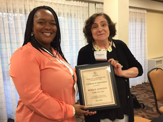 Latasha Barnes giving Roza Gossage her plaque for her work as chair of Disability Law. 
